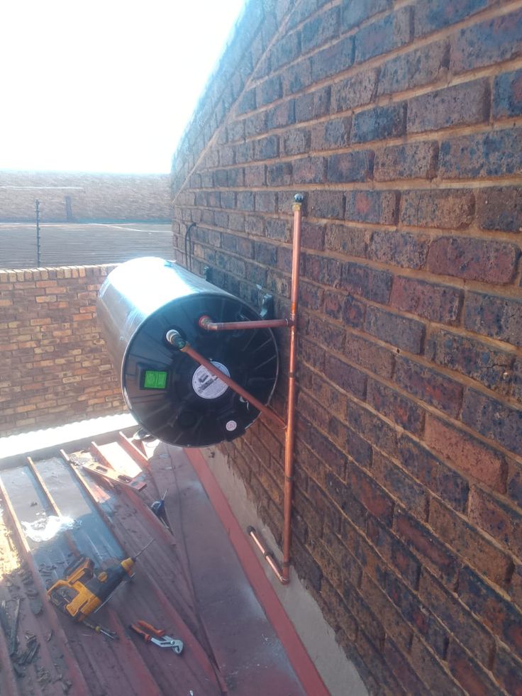 New geyser installed with copper pipework on an exterior wall